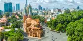 Notre Dame Cathedral with high-rise buildings in the background in Ho Chi Minh City, Vietnam.