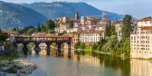 Old bridge in Bassano del grappa in Italy with the mountain peaks in the distance