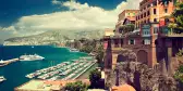 Buildings on the edge of Sorrento, with boats lined up in the water