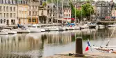 The Honfleur Harbour with docked white boats lined in a row, France