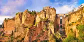 Village Ronda with rocky clifftops and Puente Nuevo bridge in Andalusia, Spain