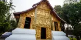 Wat Xiengthong Buddhist temple with gold exterior in Laos