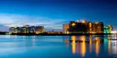 Night time shot of buildings on the edge of the water in Chennai