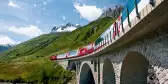 Switzerland railway Glacier Express train travelling through the Alps