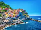 Colourful buildings along the cliffside of Cinque Terre over the Mediterranean sea