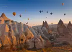Hot air balloons rising up in the sky, in Cappadocia, Turkey.