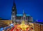 Christmas market and Catholic cathedral at night in the city of Cologne, Germany