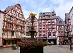 Beautiful Market Square with fountain, flowers and half timbered buildings in Bernkastel-Kues, Germany
