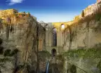 Village Ronda sitting on rocky clifftops and Puente Nuevo, a bridge in Ronda in Andalusia, Spain. 