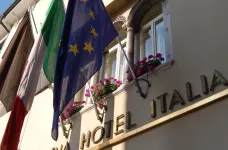 Exterior of Hotel Astoria with flags in Udine, Italy