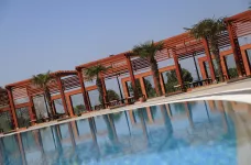 Kolin Hotel poolside and sun shade pergolas in rows over twin sun loungers 