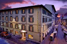 Exterior of the Hotel Corona D'Italia at twilight in Florence, Italy