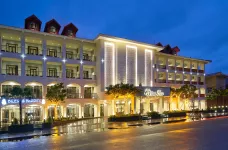 Evening exterior of Senna Hue Hotel under a calm cloudy sky, Vietnam