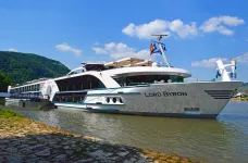 Side view of the MS Lord Byron docked near the coast