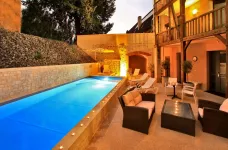 Outdoor pool at Hotel le Compostelle during the evening in Sarlat, France