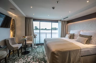 Interior of double bedroom cabin with window view aboard the William Wordsworth ship