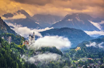 Neschwanstein Castle with vegetation and mist in the Bavarian Alps, Germany