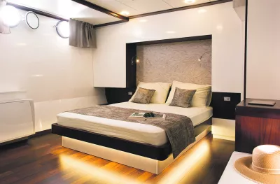 MV corona double bed Cabin with small porthole windows letting in natural light