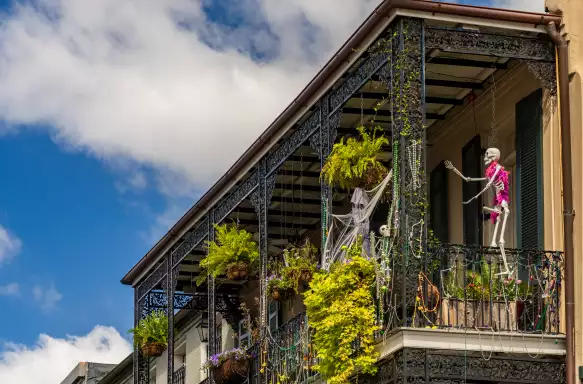 Halloween decorations on traditional New Orleans building in the French Quarter with wrought iron balconies