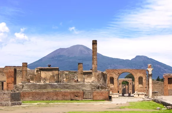 Ruins of Pompeii and a distant view of Mount Vesuvius volcano in Italy
