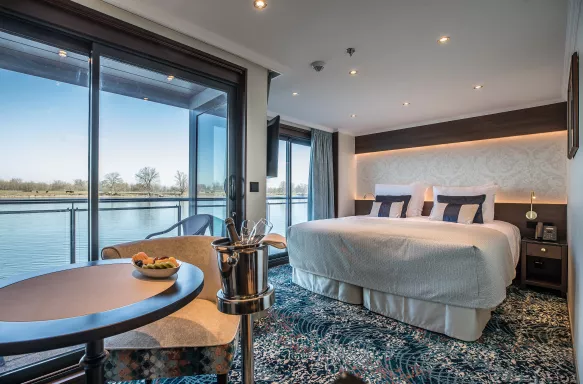 Interior of bedroom with floor to ceiling window view aboard the George Eliot ship