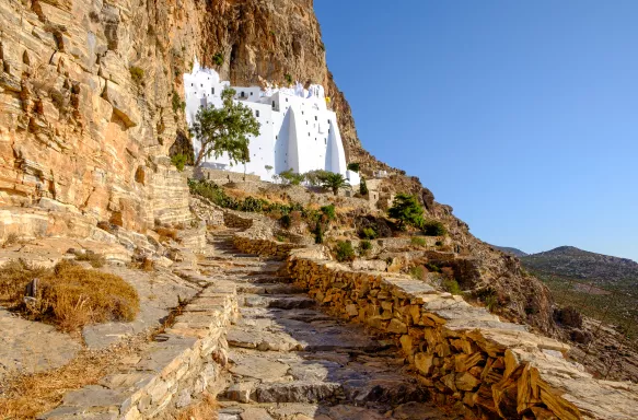 Rock steps heading towards white Monastery of the Virgin Mary in Greece