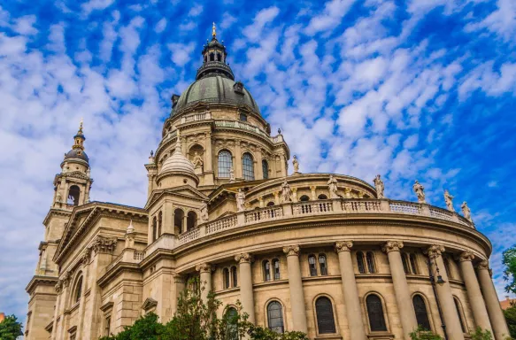 View of St. Stephens Basilica against a cloudy blue sky in Budapest, Hungary