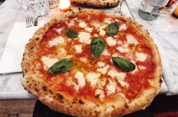 Napolitana Italian pizza with basil leaves at restaurant