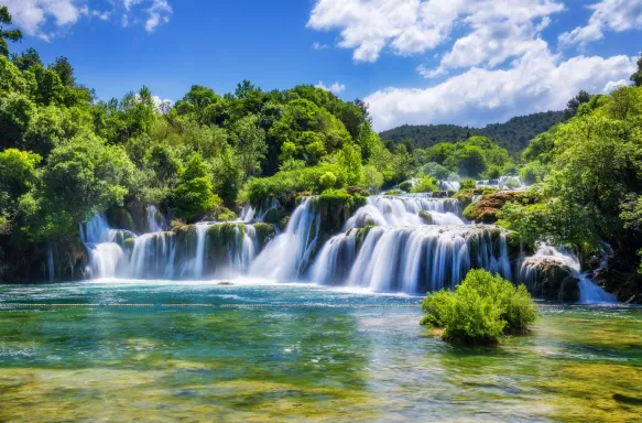 Croatian Krka Park waterfalls surrounded by green trees