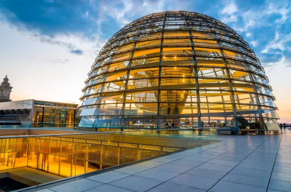 Illuminated Reichstag building, glass dome modern monument with spiral walkways to the top