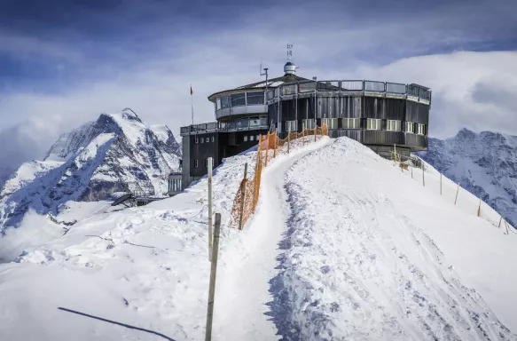 Alps cable car station on snowy winter mountain peak in Switzerland