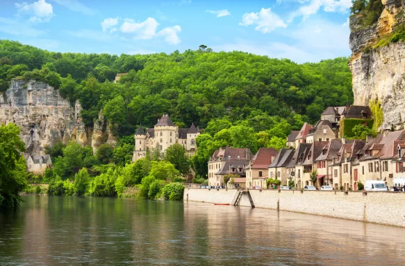 The Roque-Gageac with rocky cliffs and vegetation in Dordogne, France.