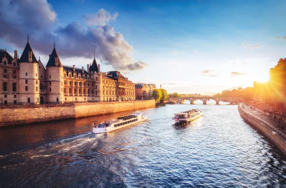 An image of two ships crossing the Seine River, during the day