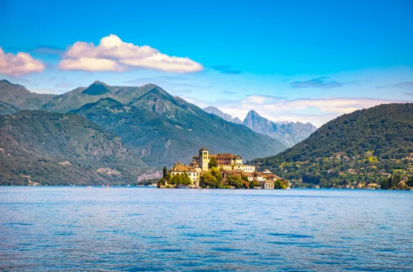 Distant view of Orta San Giulio village and Alps mountains view in Piedmont, Italy