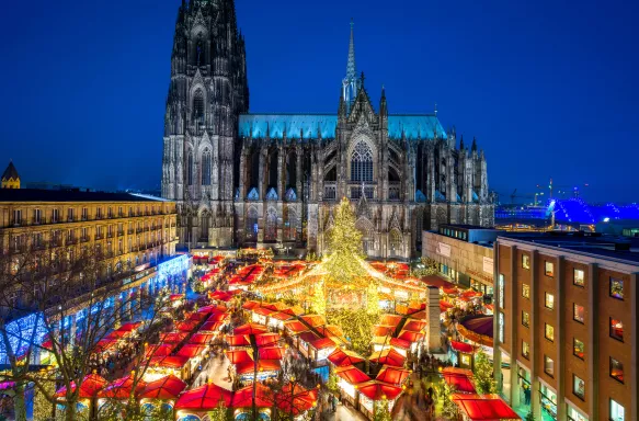 Christmas market and Catholic cathedral at night in the city of Cologne, Germany