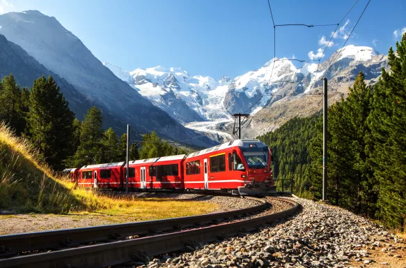 Red and white Swiss train in the alps mountains, Switzerland