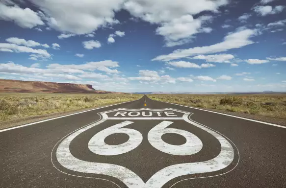 Highway sign for Route 66 on asphalt of country road
