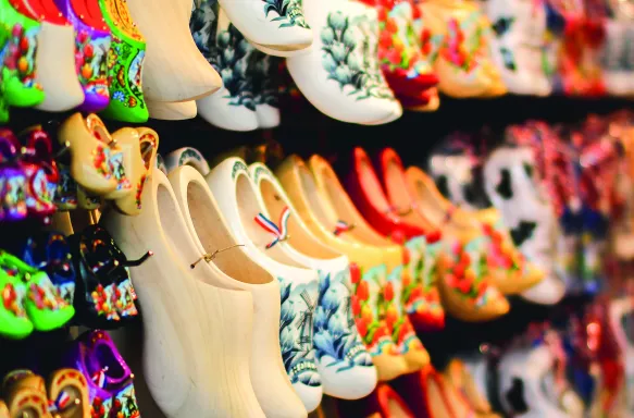 Shoes of a variety of colours hanging on display