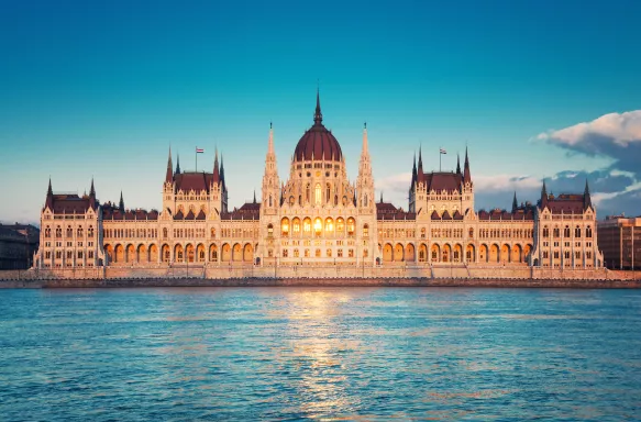 Parliament building with sun setting in windows in Budapest, Hungary