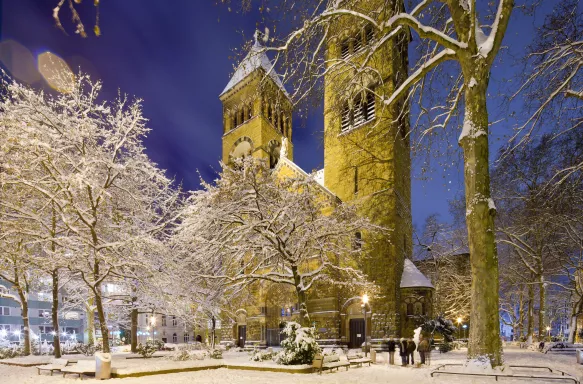 St. Michael church covered in snow at night in Cologne, Germany