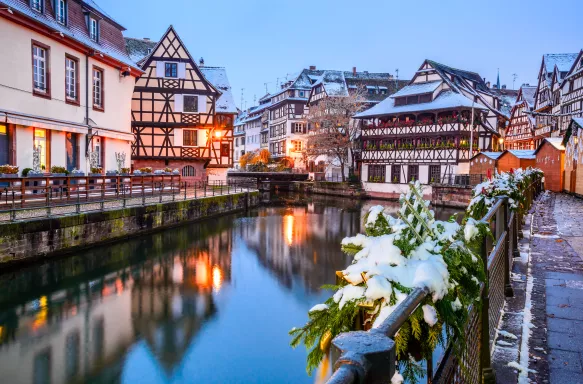 Canal and illuminated buildings during a Christmas market in Strasbourg, France