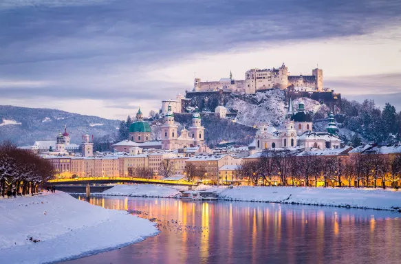 Classic view of Salzburg and Festung Hohensalzburg fortress illuminated at Christmas time in Austria