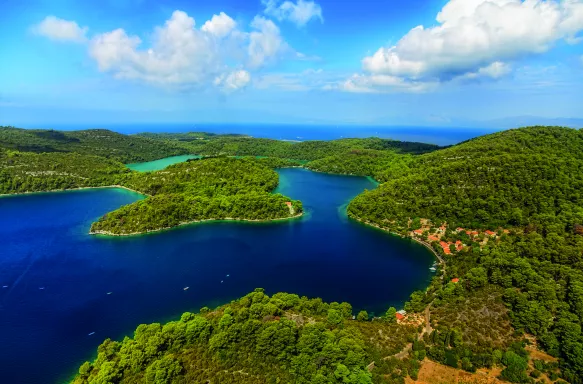 Aerial shot of the National Park on the island of Mijet, Croatia. Also known as a “green island” for its lush vegetation, its beauty consists of contrasting rocks, caves and cliffs against blue waters.