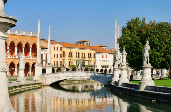 Padua city with statues and mini bridge over water, Italy