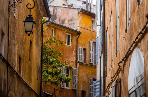 Narrow street between buildings in Aix Old town, France