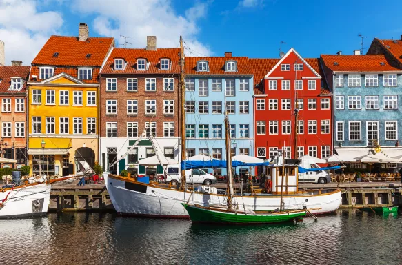 Colourful row of houses and canal with boats in Copenhagen, Denmark