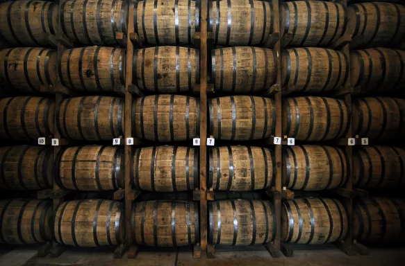 Stacked wooden whiskey barrels