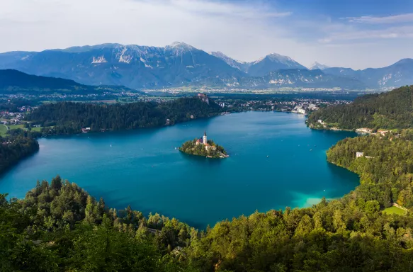 Wide shot of Lake Bled with greenery and mountains in Slovenia, Europe