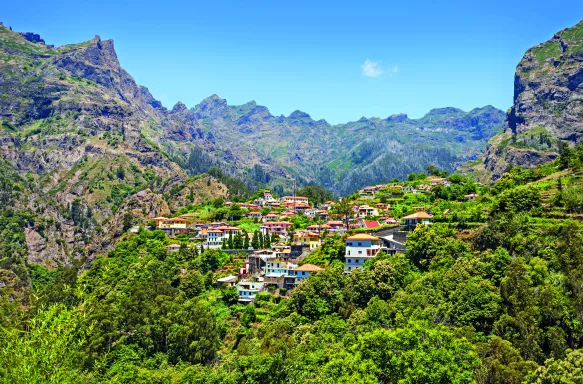 Village nestles between the copse covered mountains, Curral das Freiras