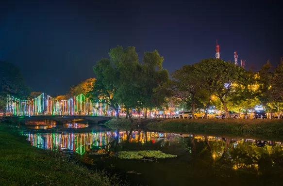 Colourful lights in siem reap overlooking the water, cambodia.